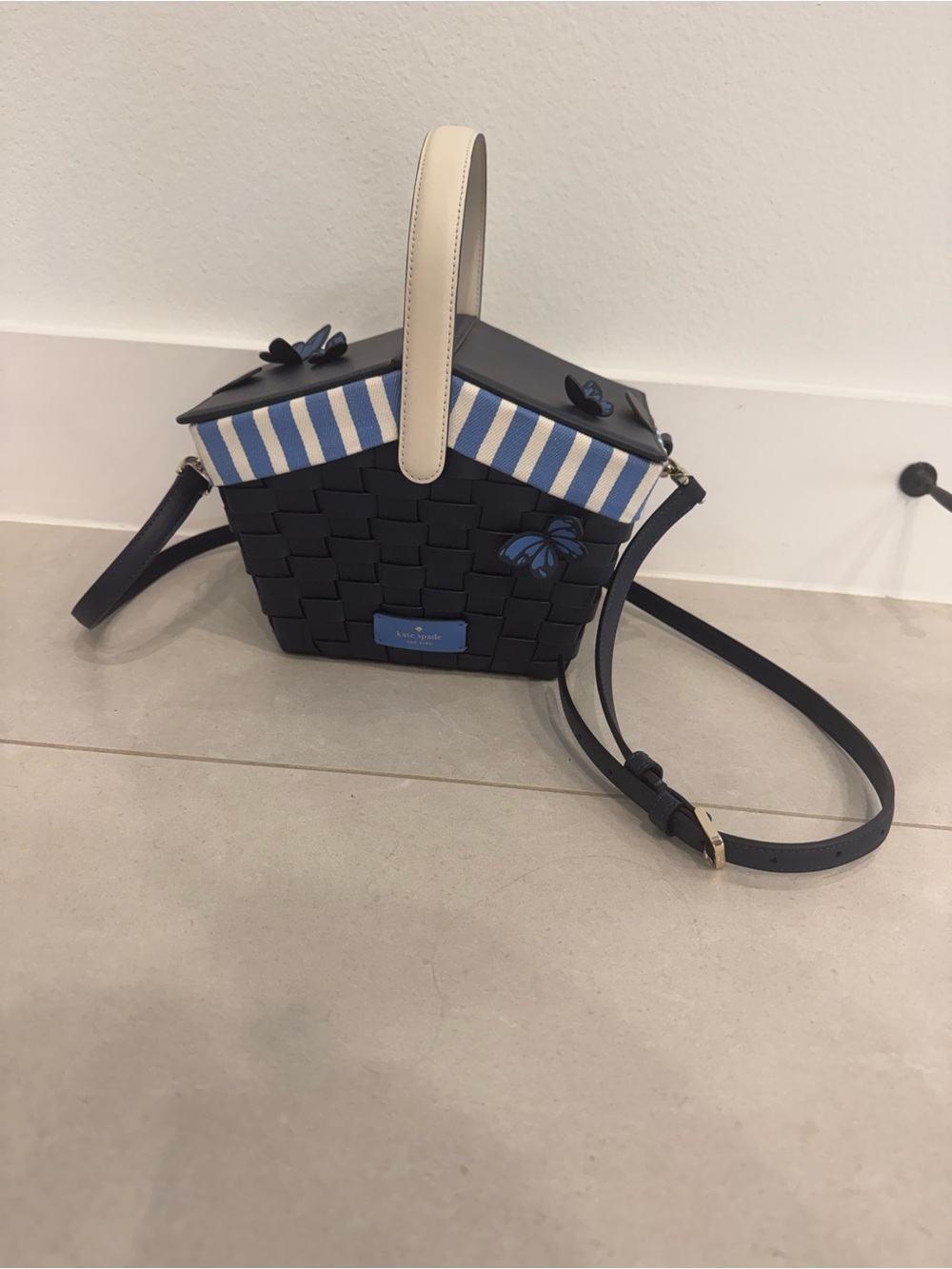 kate spade navy woven basket crossbody with cream handle and blue stripe
